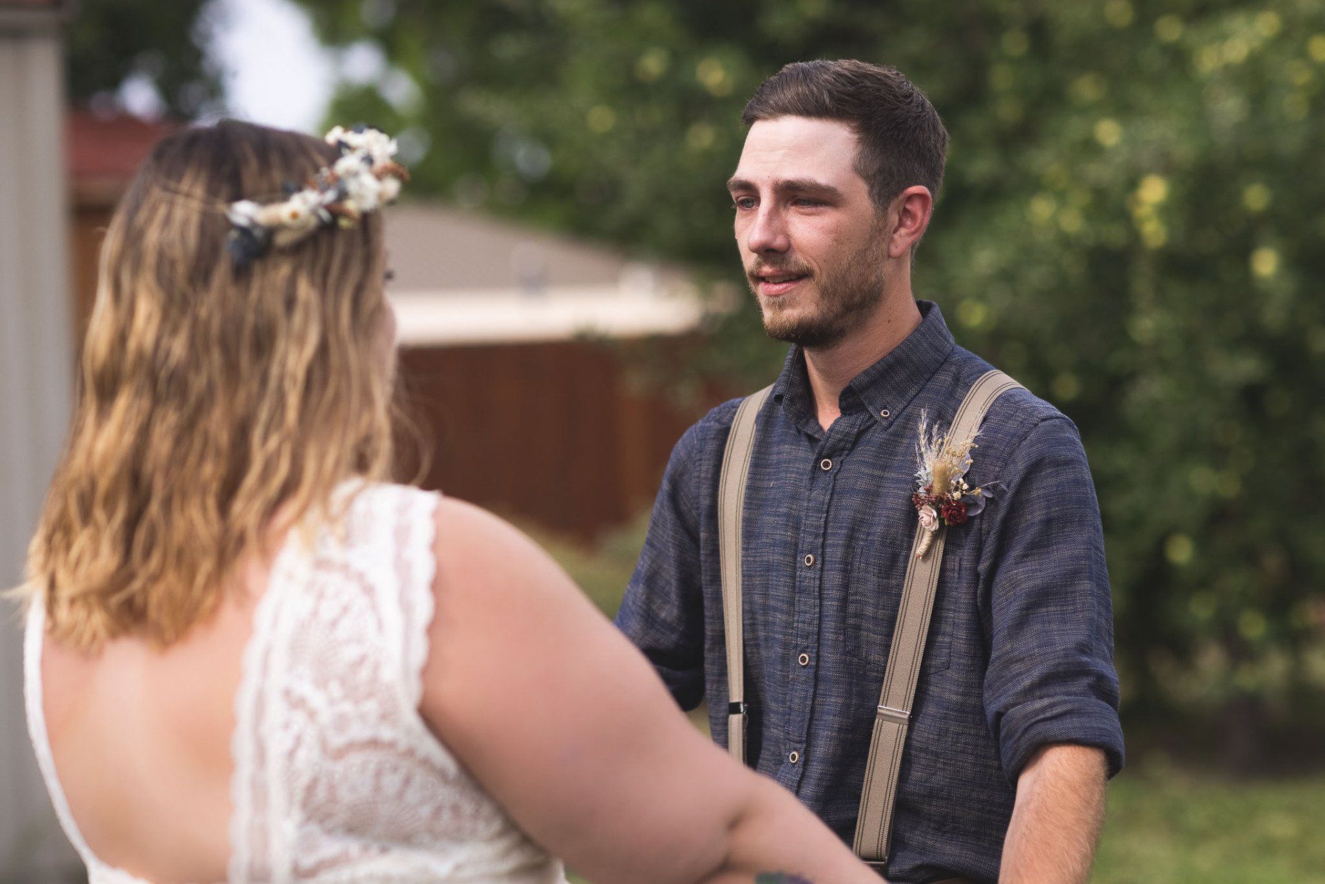 A bride and groom are holding hands during their wedding ceremony.