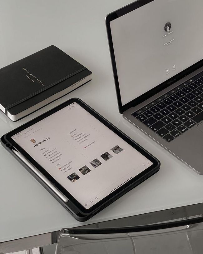A laptop and a tablet are sitting on a desk.