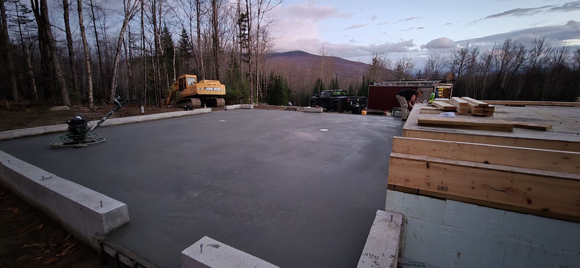 A concrete floor is being built in the middle of a forest.
