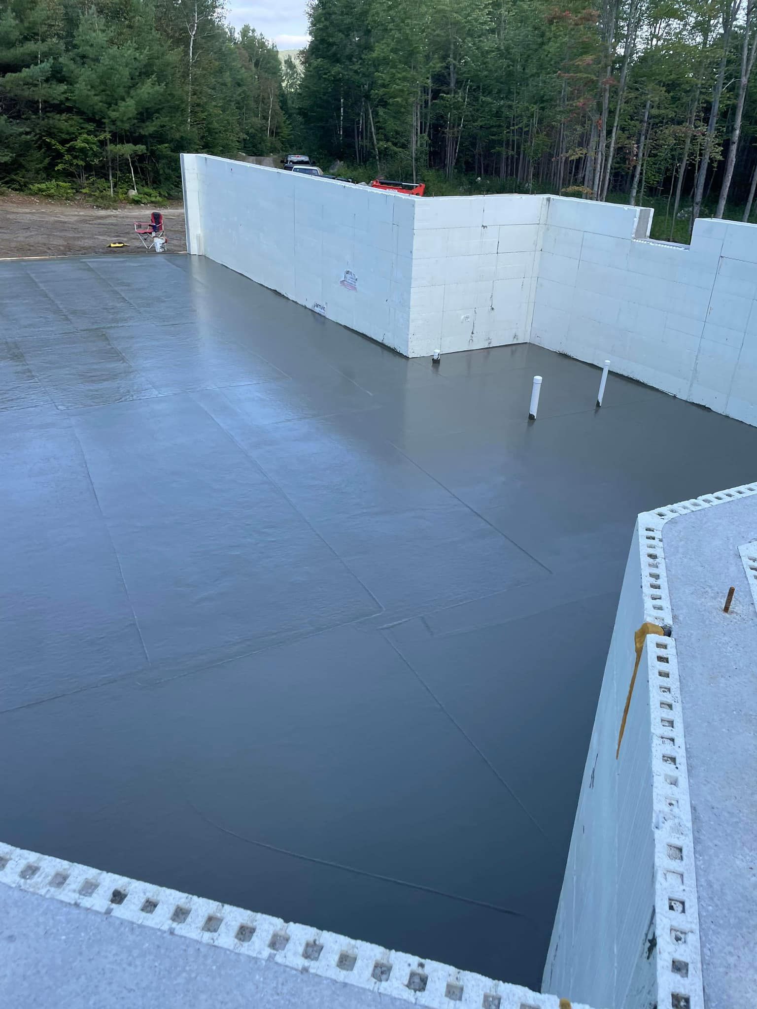 A large pool is being built in the middle of a forest.