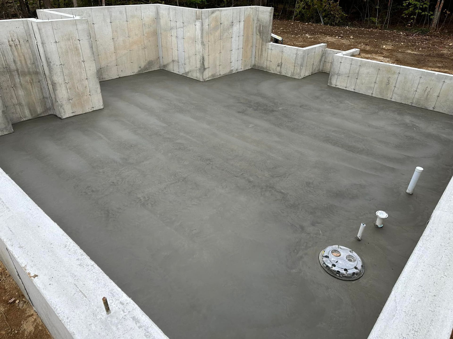 A concrete base for a house is being built.