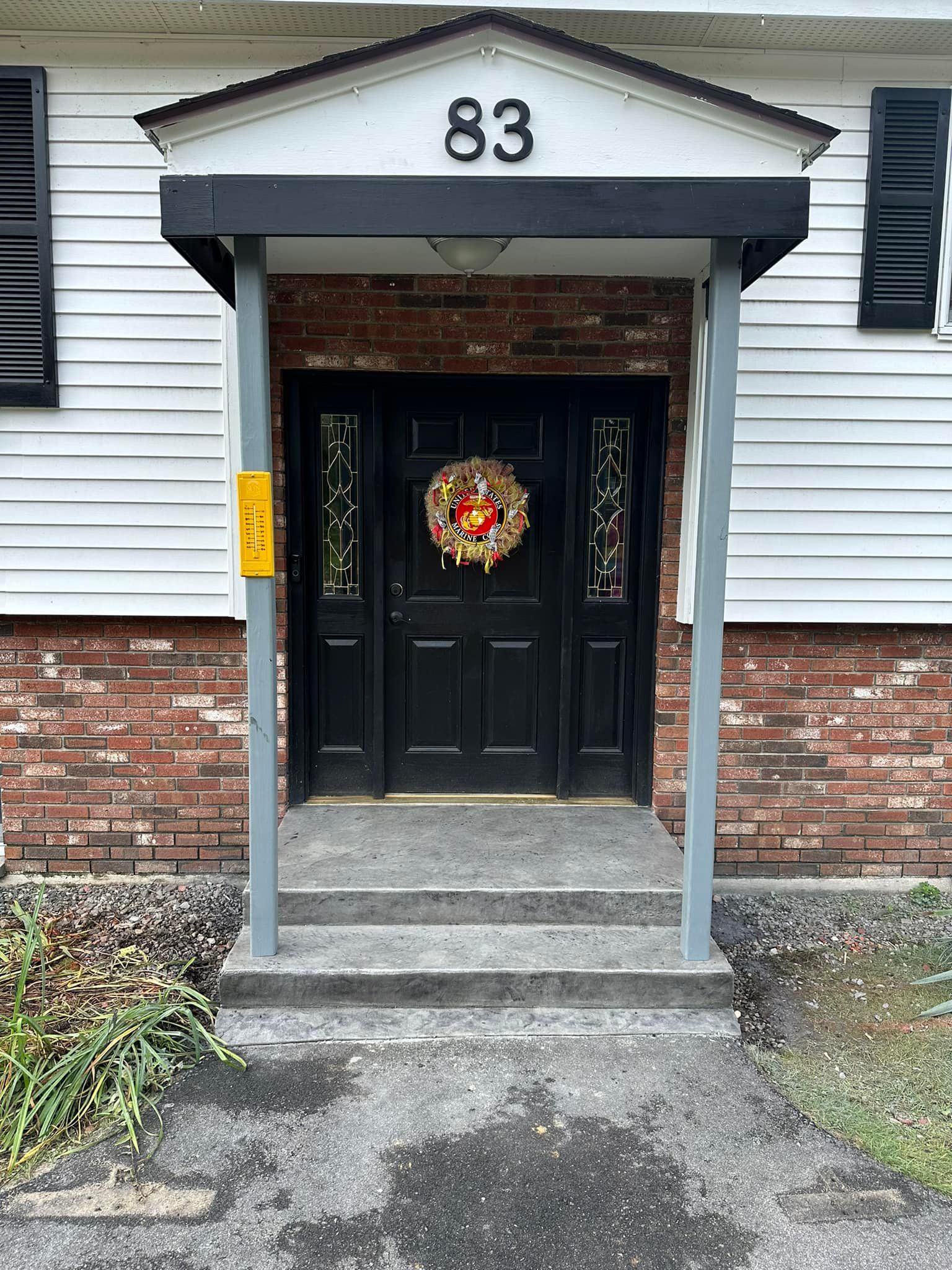The front door of a house with the number 83 on it
