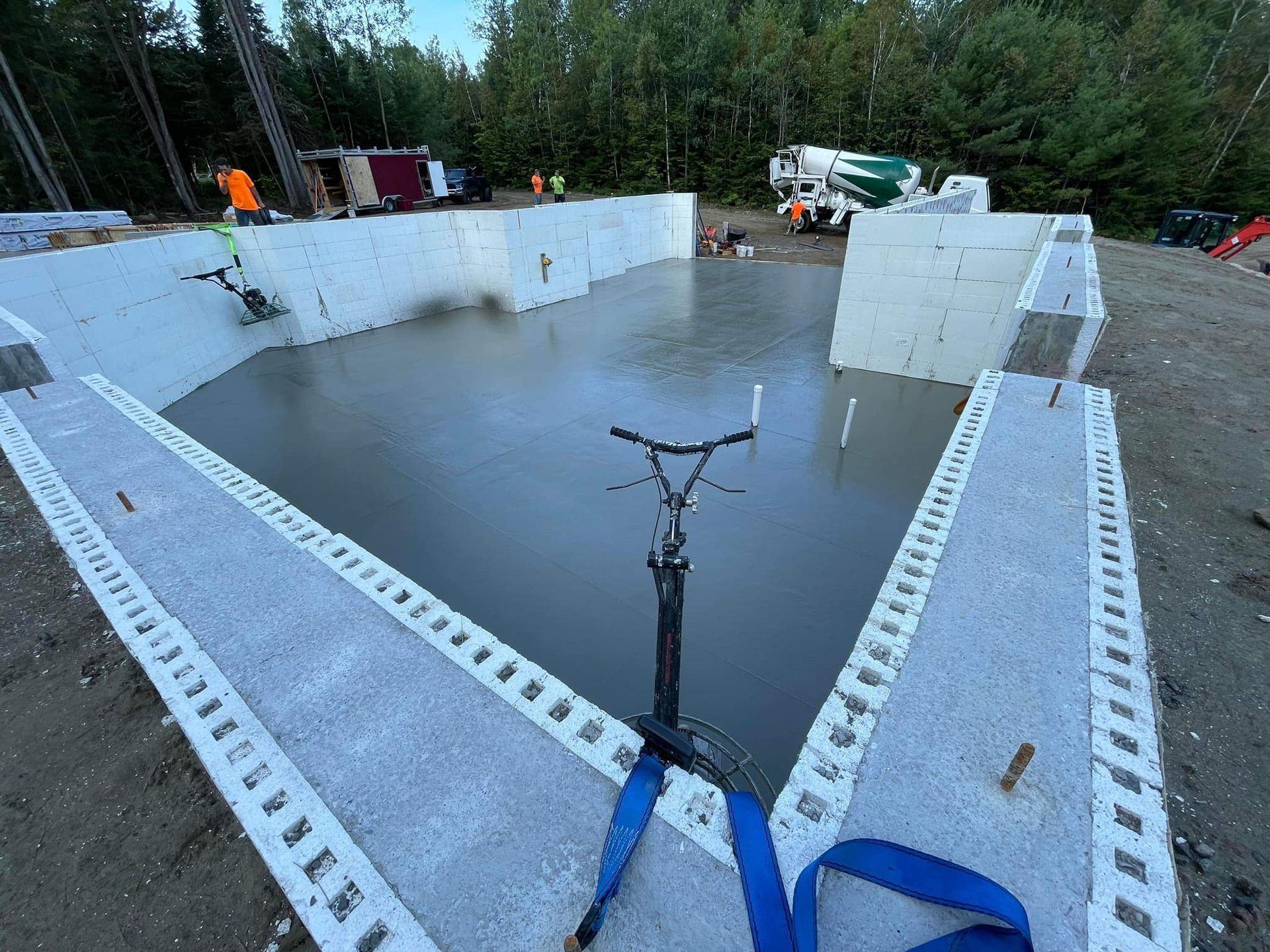 A scooter is sitting on top of a concrete pool.