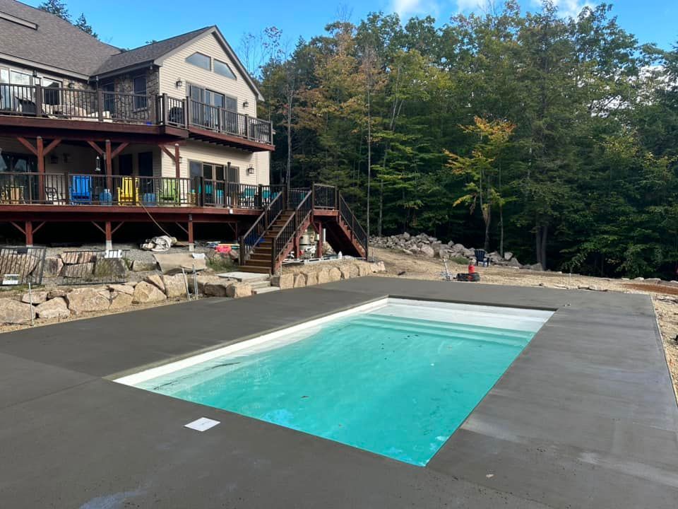 A large house with a large swimming pool in front of it.