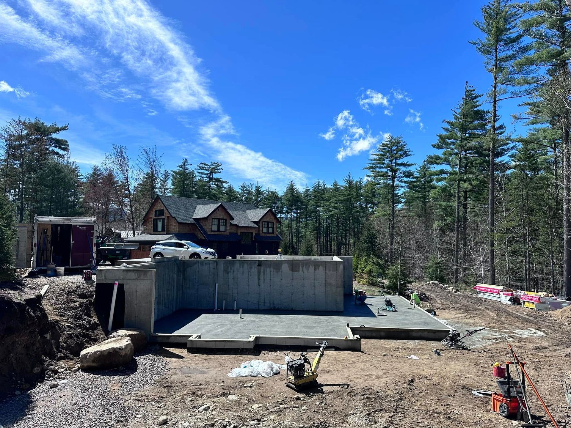A large house is being built in the middle of a forest.