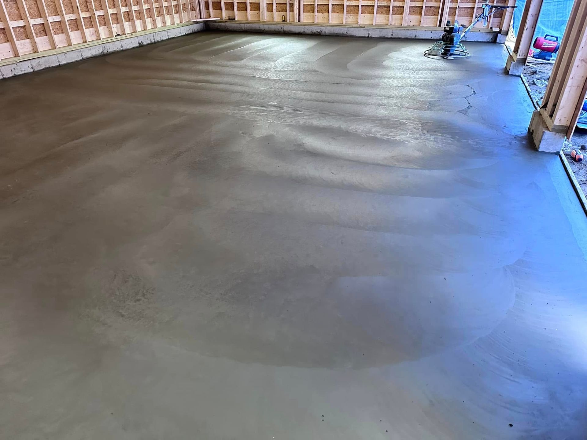 A concrete floor in a garage under construction.