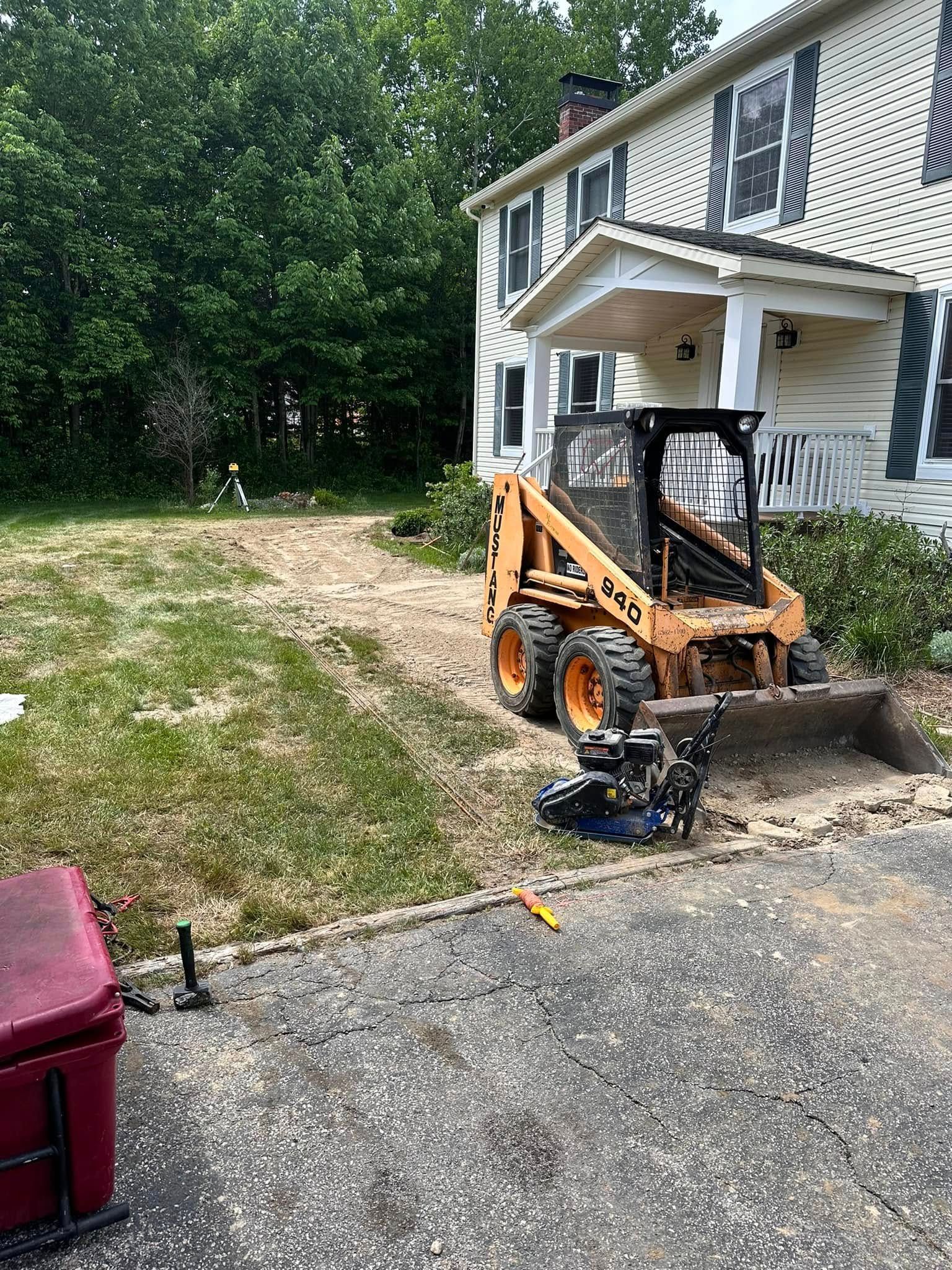 A small bulldozer is parked in front of a house.