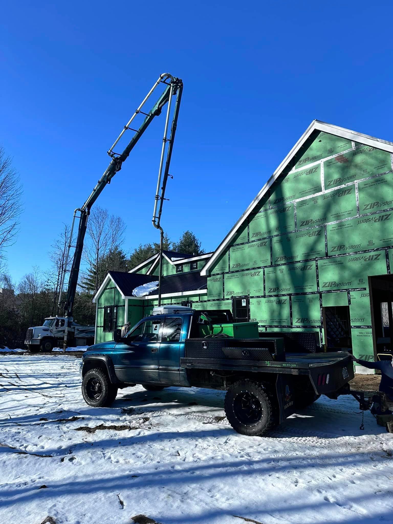 A truck is parked in front of a building under construction.