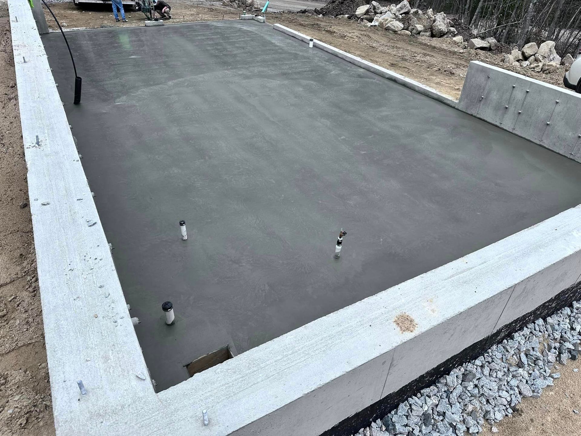 A concrete base for a house is being built.