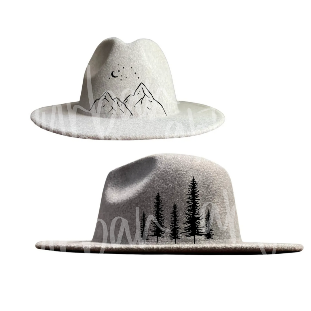 Two white hats with mountains and trees painted on them