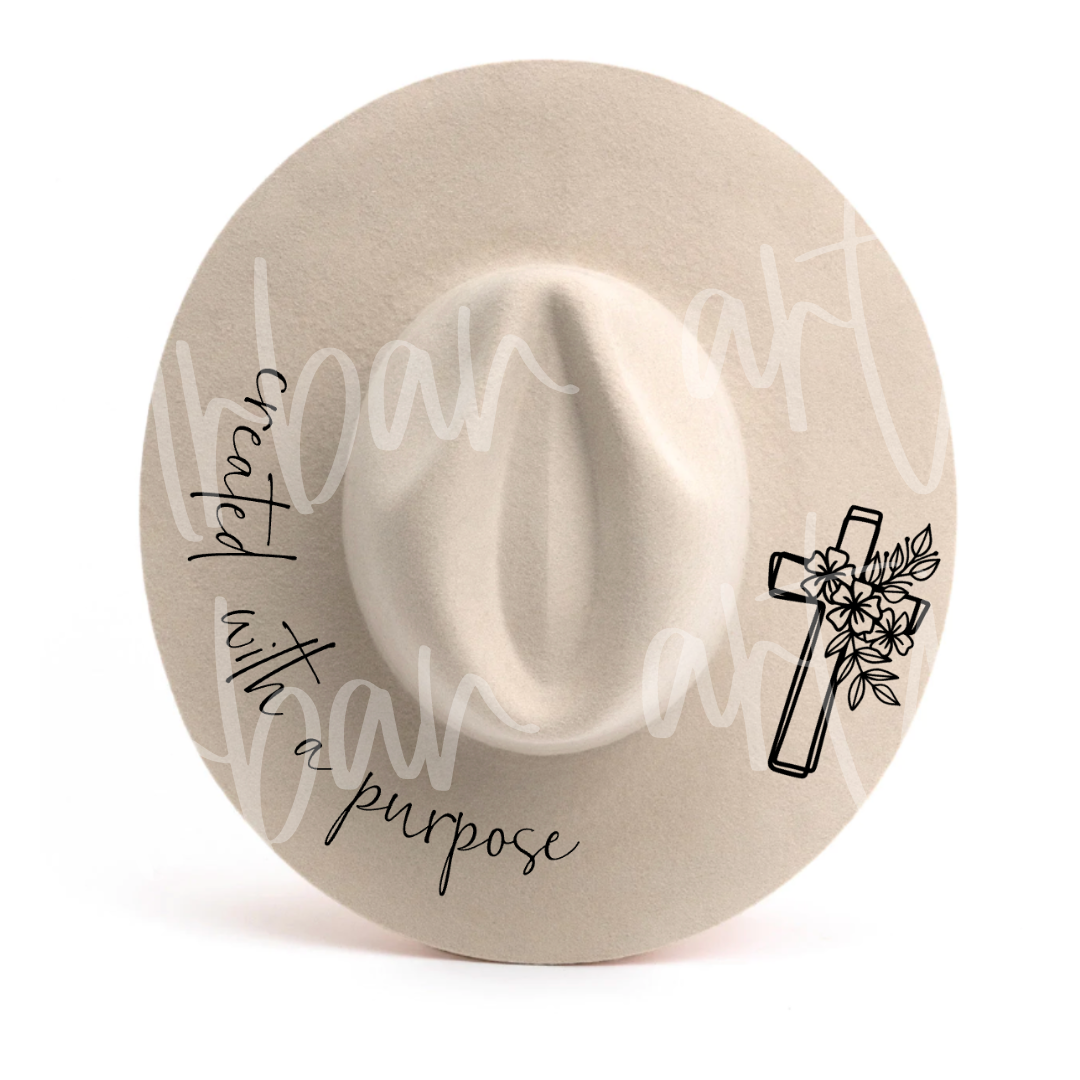 A hat with the words created with a purpose and a cross on it