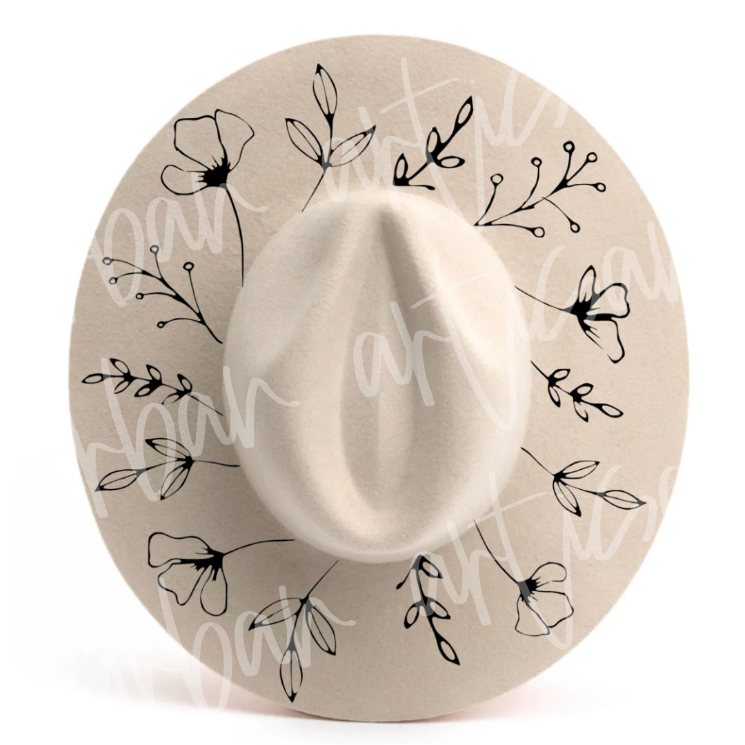 A white hat with black flowers and leaves on it