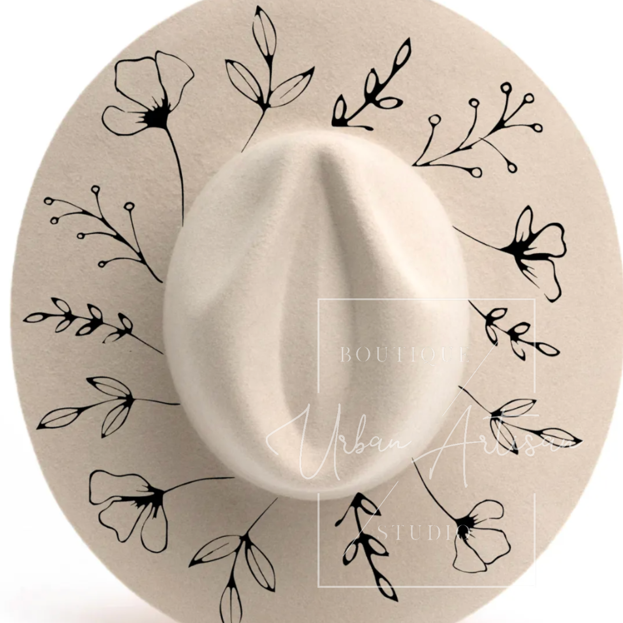 A white hat with black flowers and leaves on it