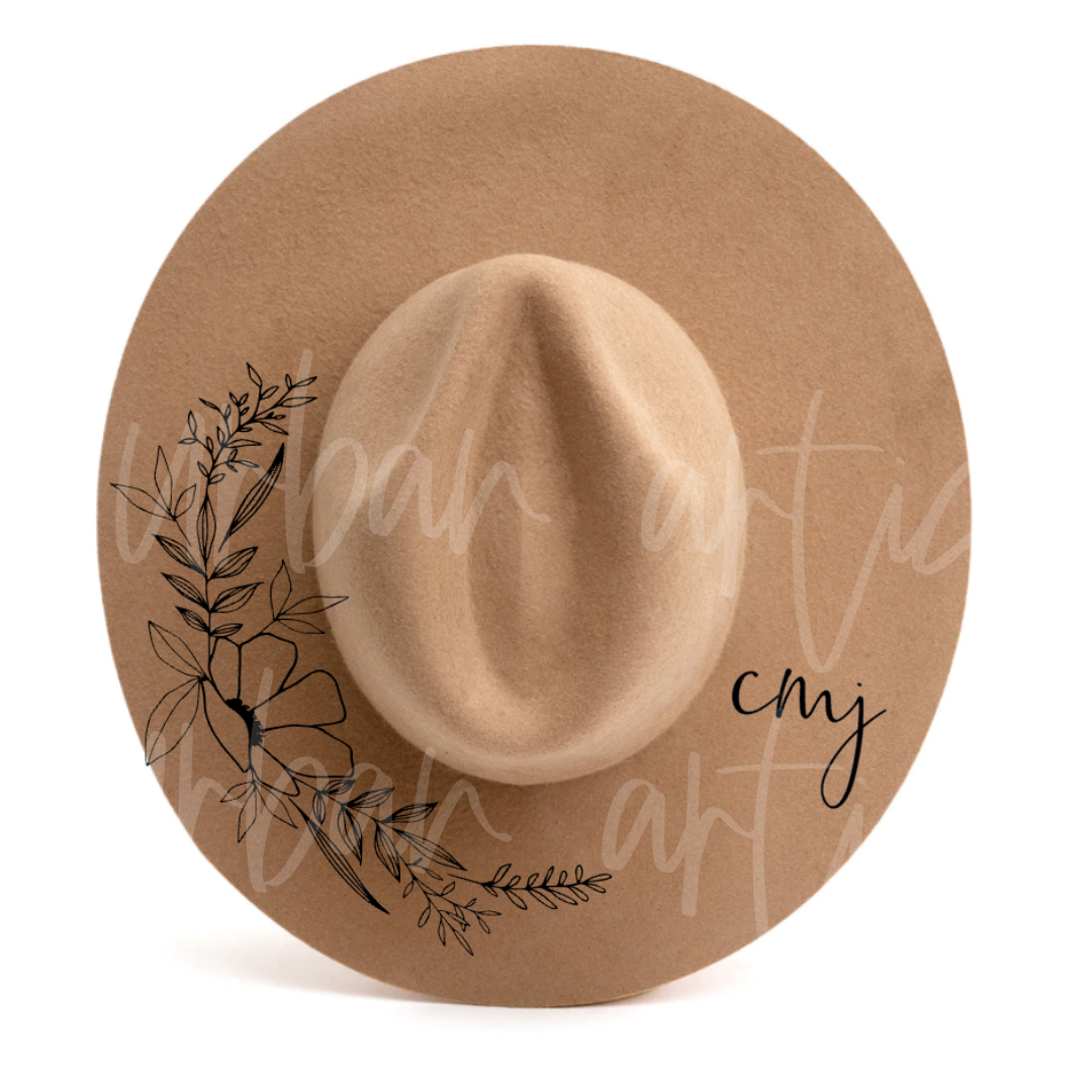 A hat with a floral design and the words cmy on it
