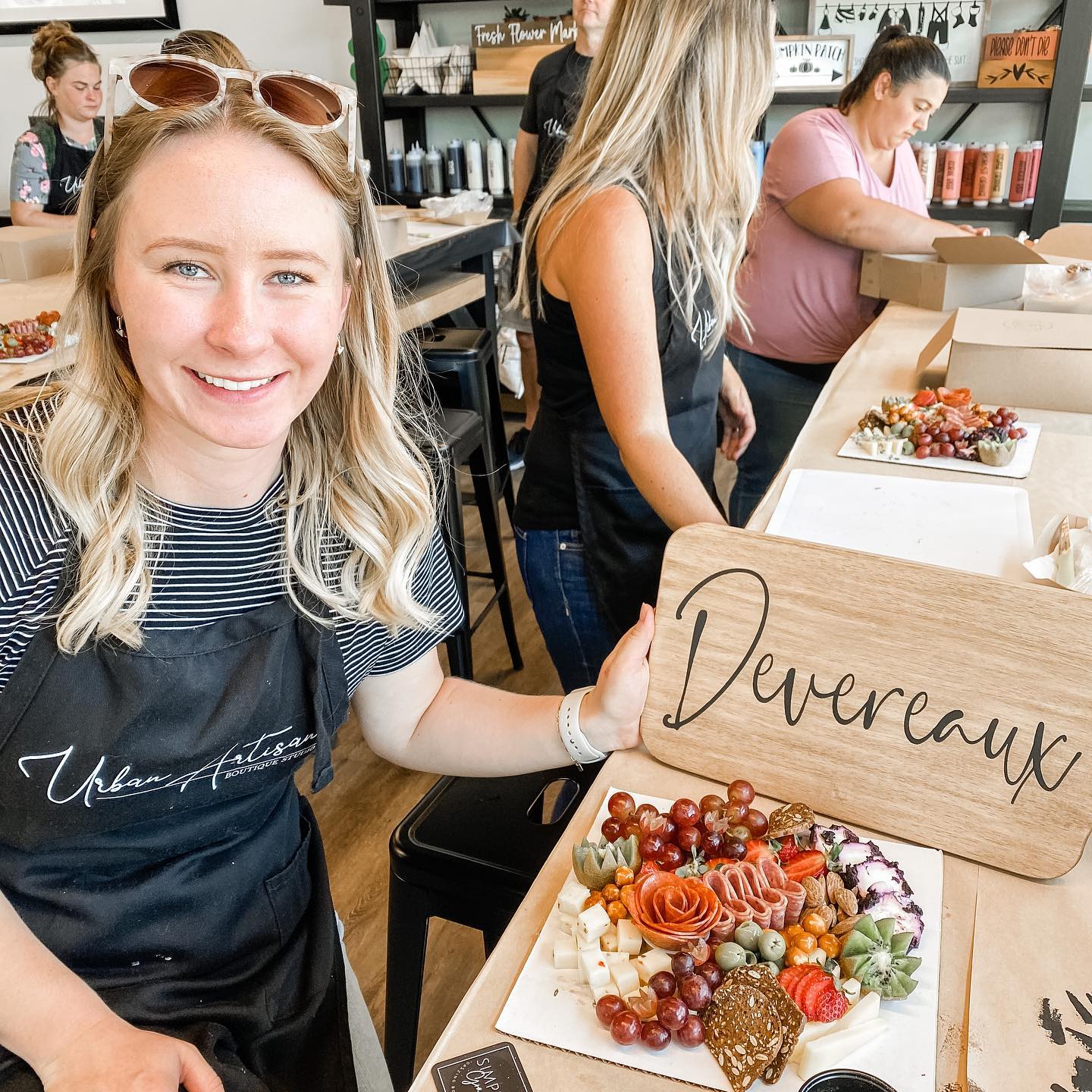 A woman is holding a sign in front of a plate of food.