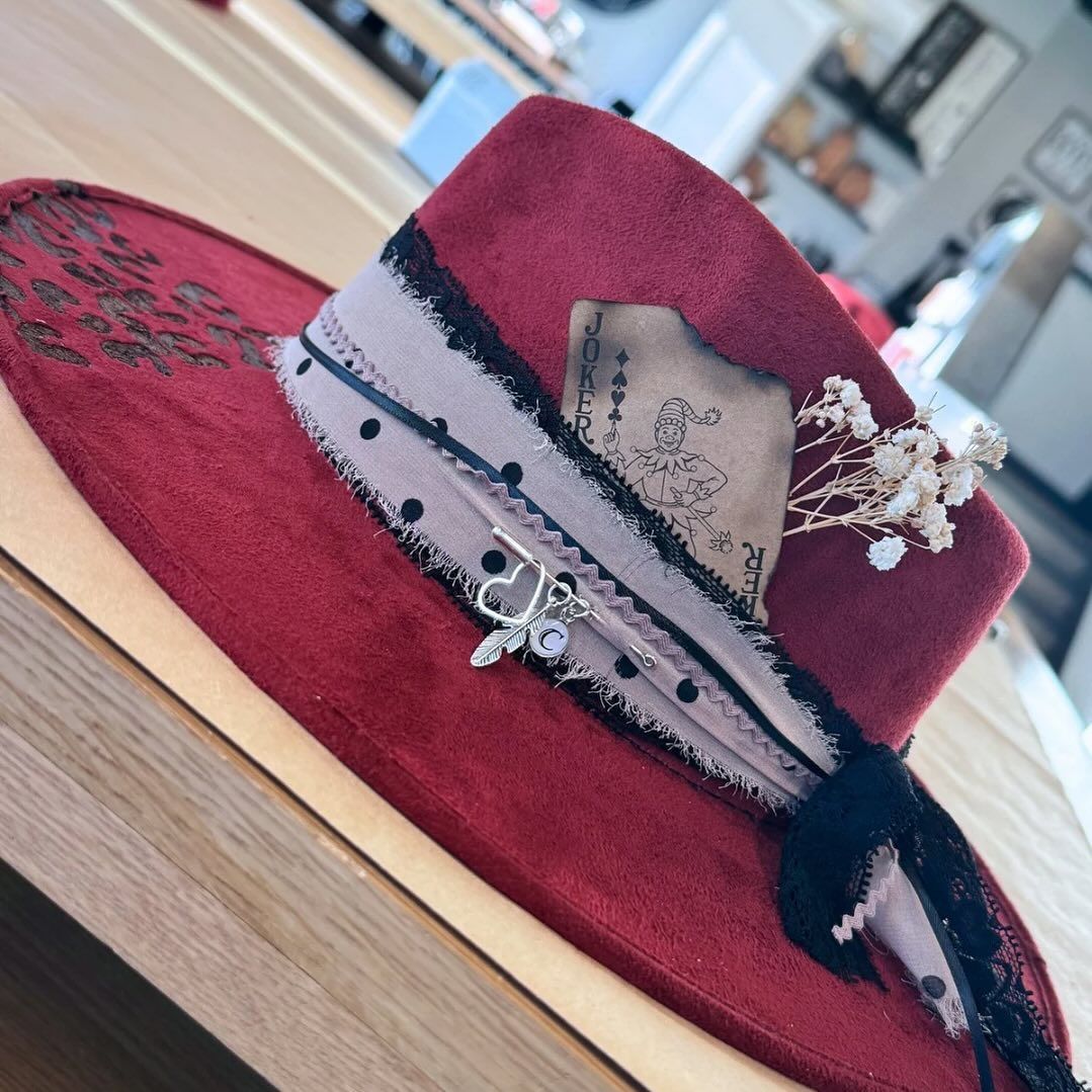 A red hat is sitting on a wooden table