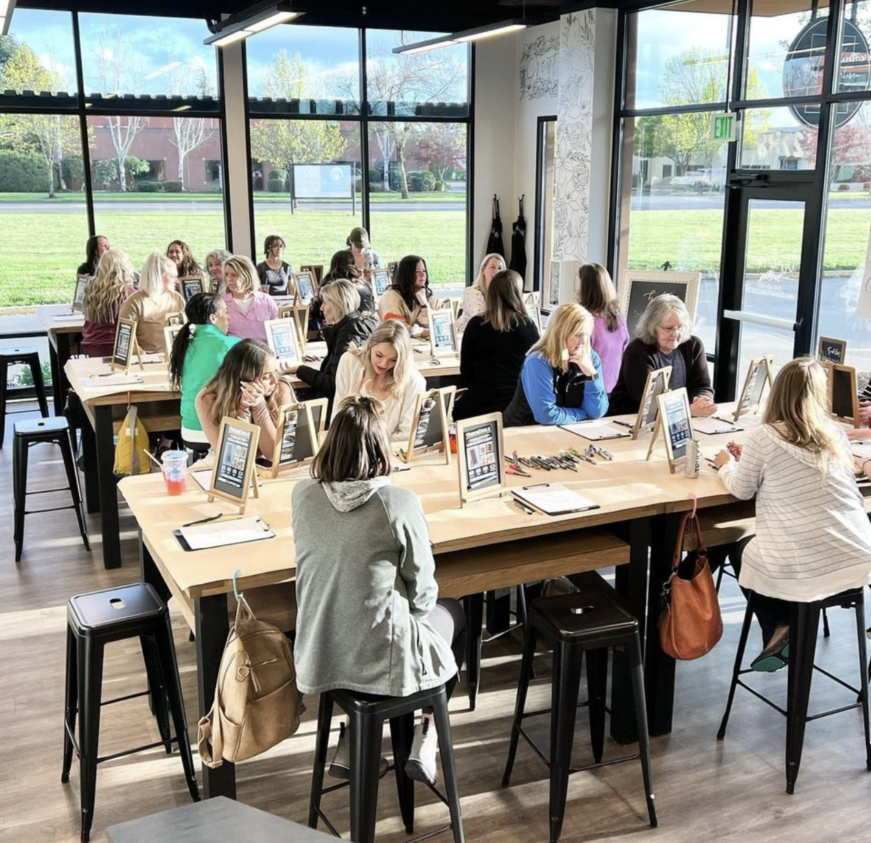 A group of people are sitting at tables in a room.