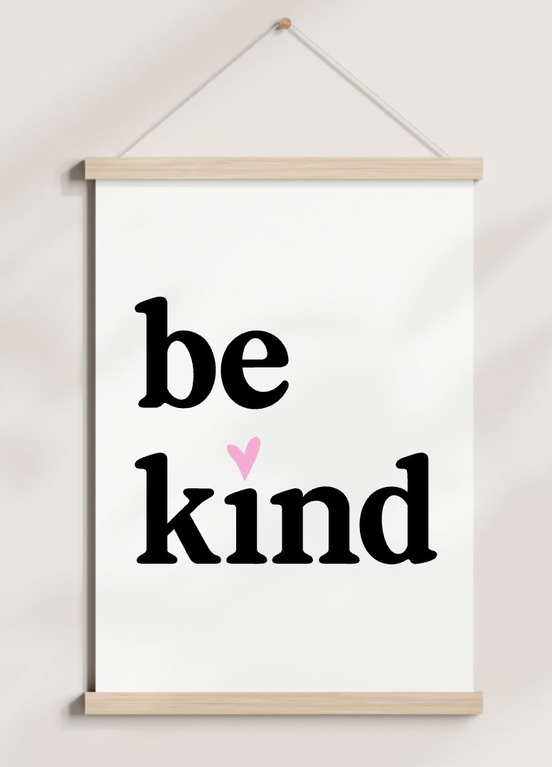 A poster hanging on a wall that says be kind