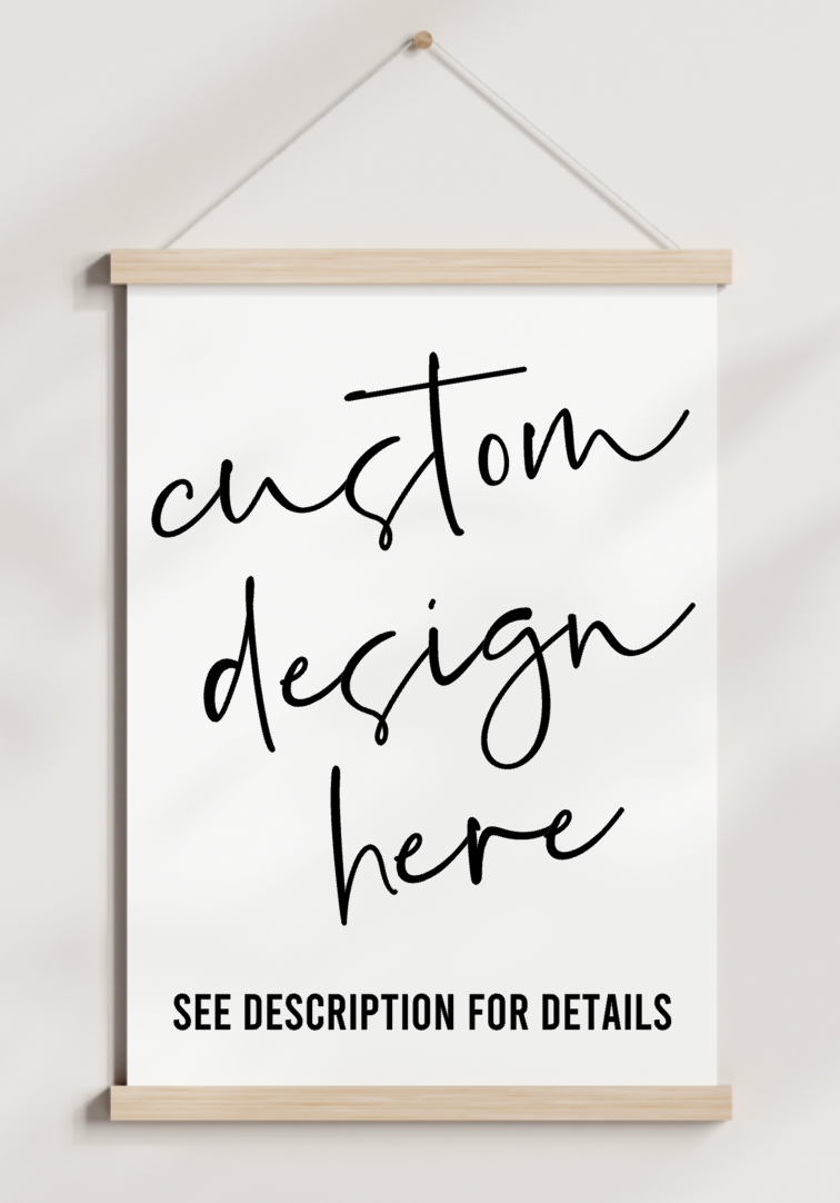 A sign that says custom design here is hanging on a wall.