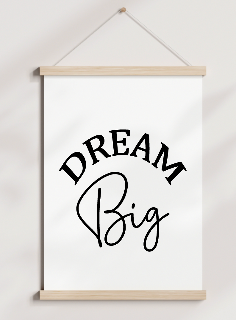 A poster hanging on a wall that says dream big