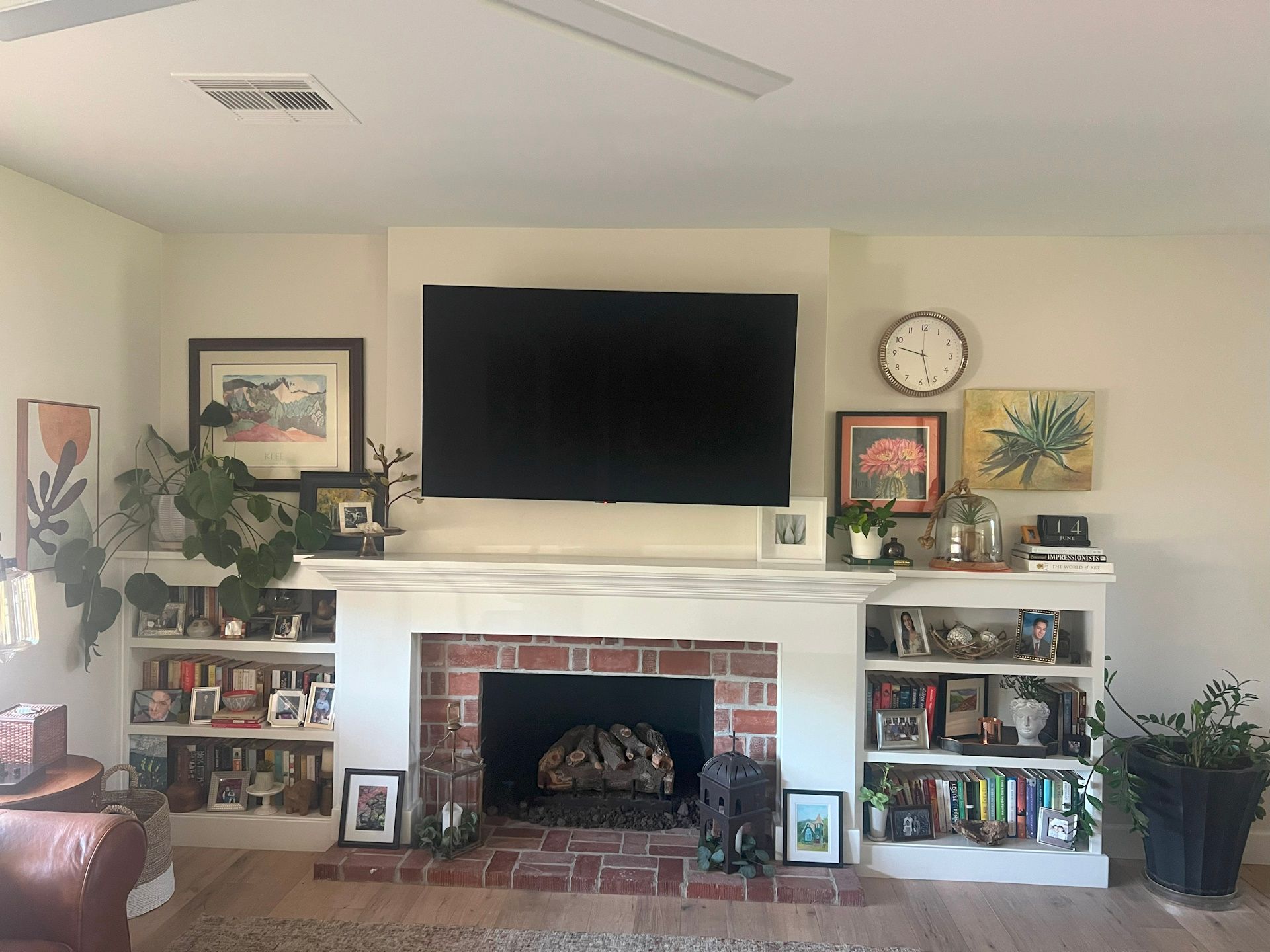 A living room with a fireplace and a flat screen tv.