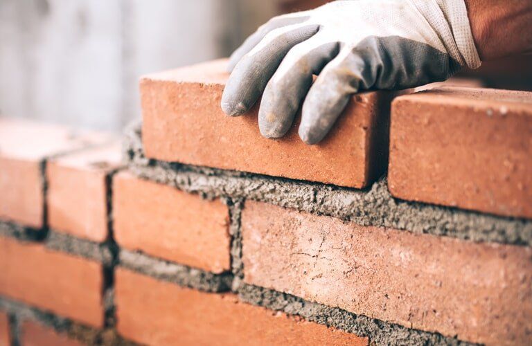 Man Hand Holding Brick — Bricklayers In St Georges Basin, NSW
