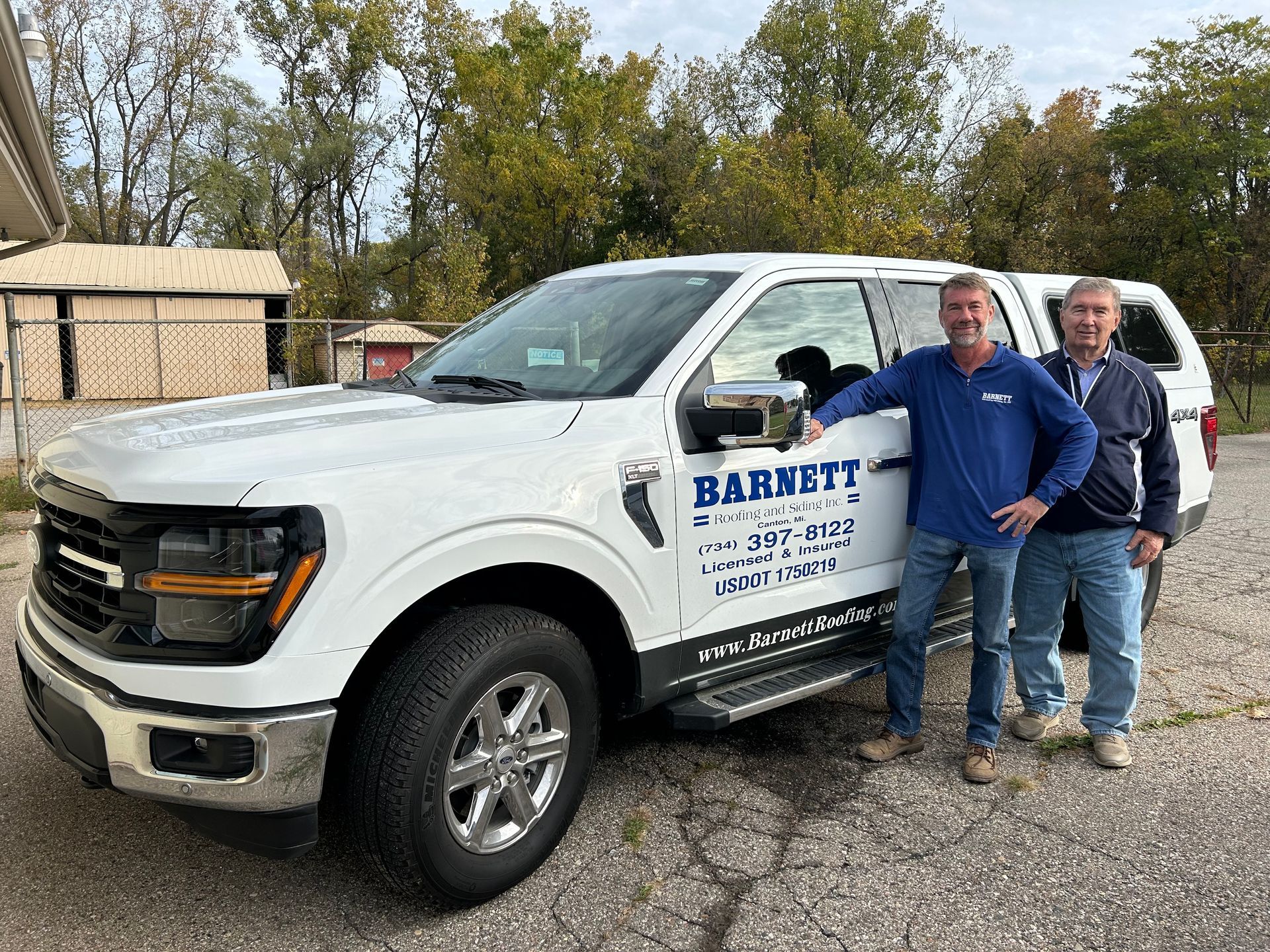 Roofing Specialists — Men Standing Behind Truck in Canton, MI