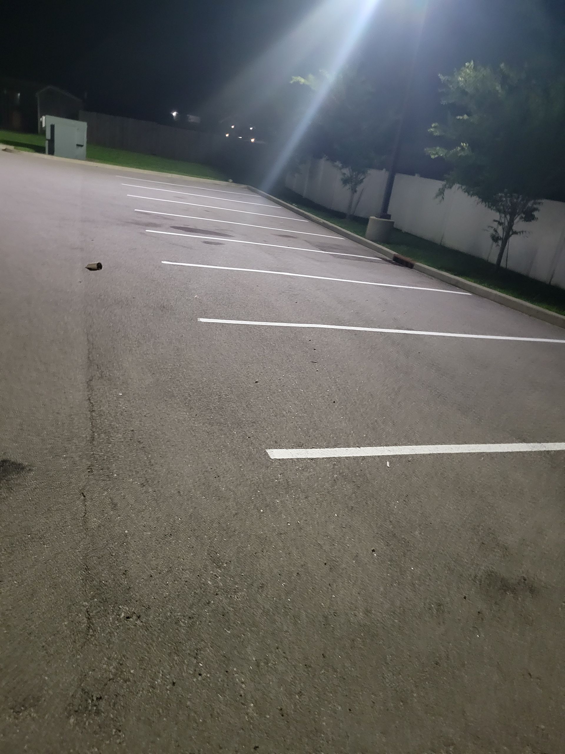 A parking lot with white lines on it at night