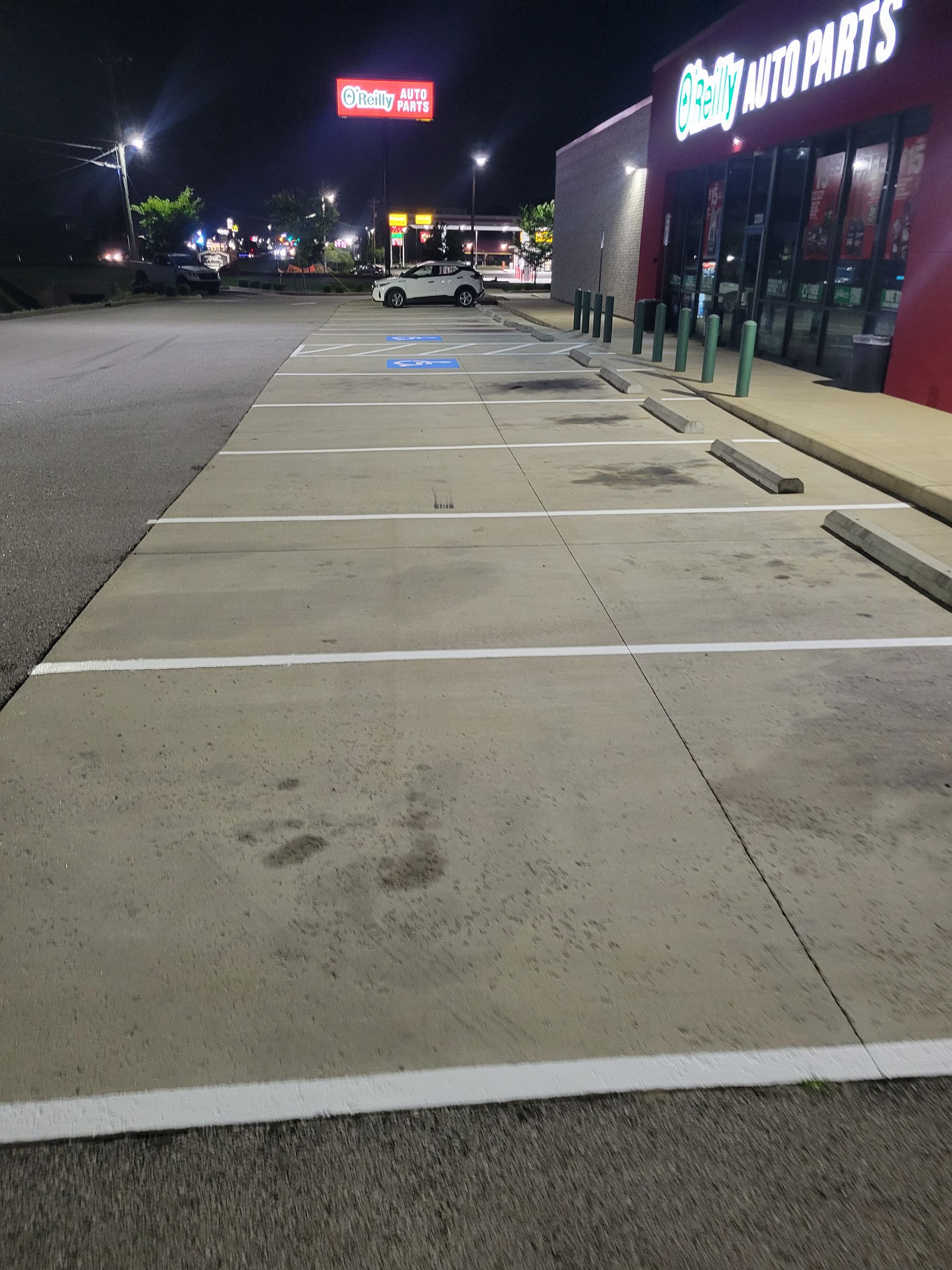 A parking lot in front of a store that says auto parts