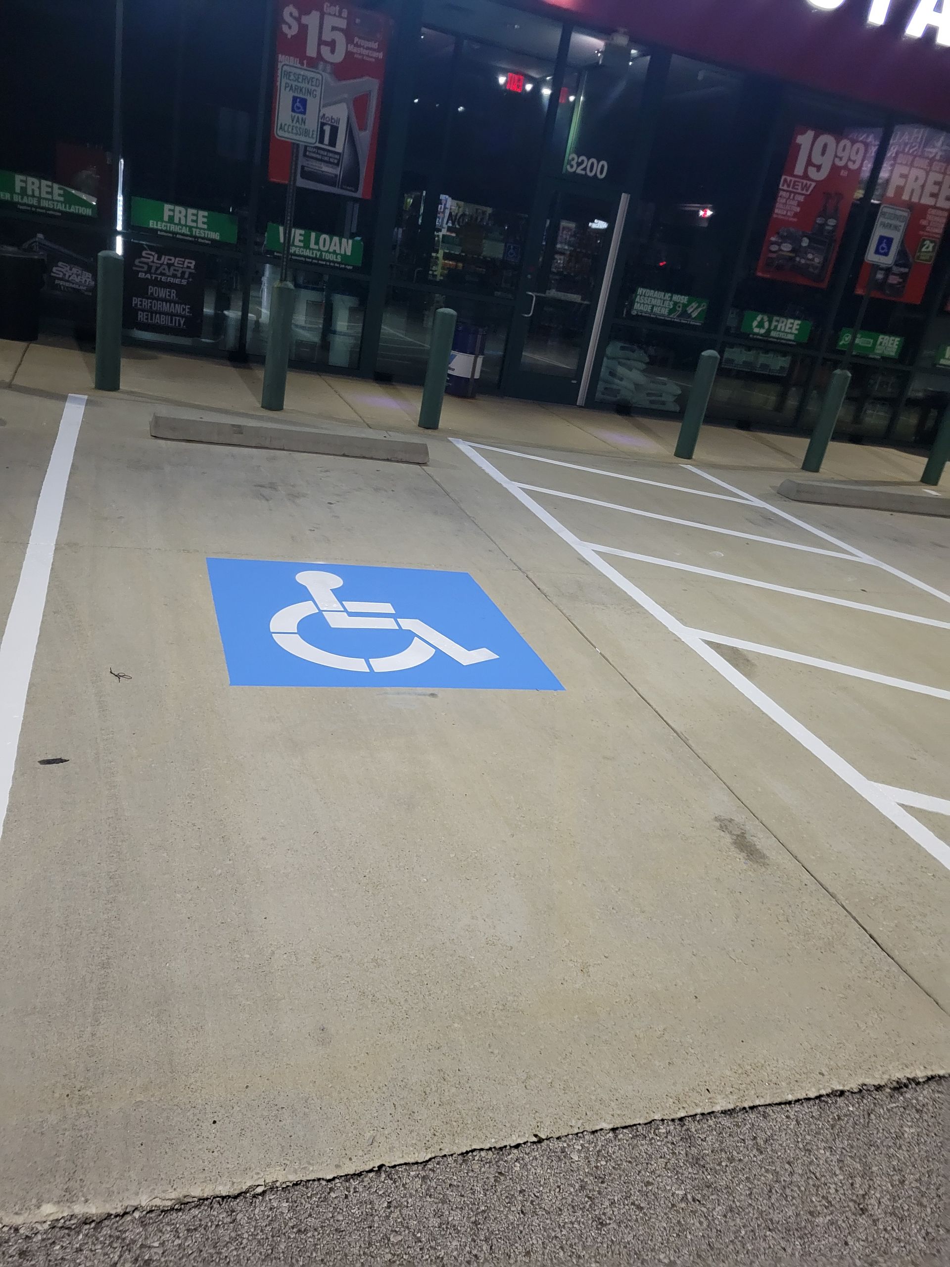 A handicapped parking spot in front of a store
