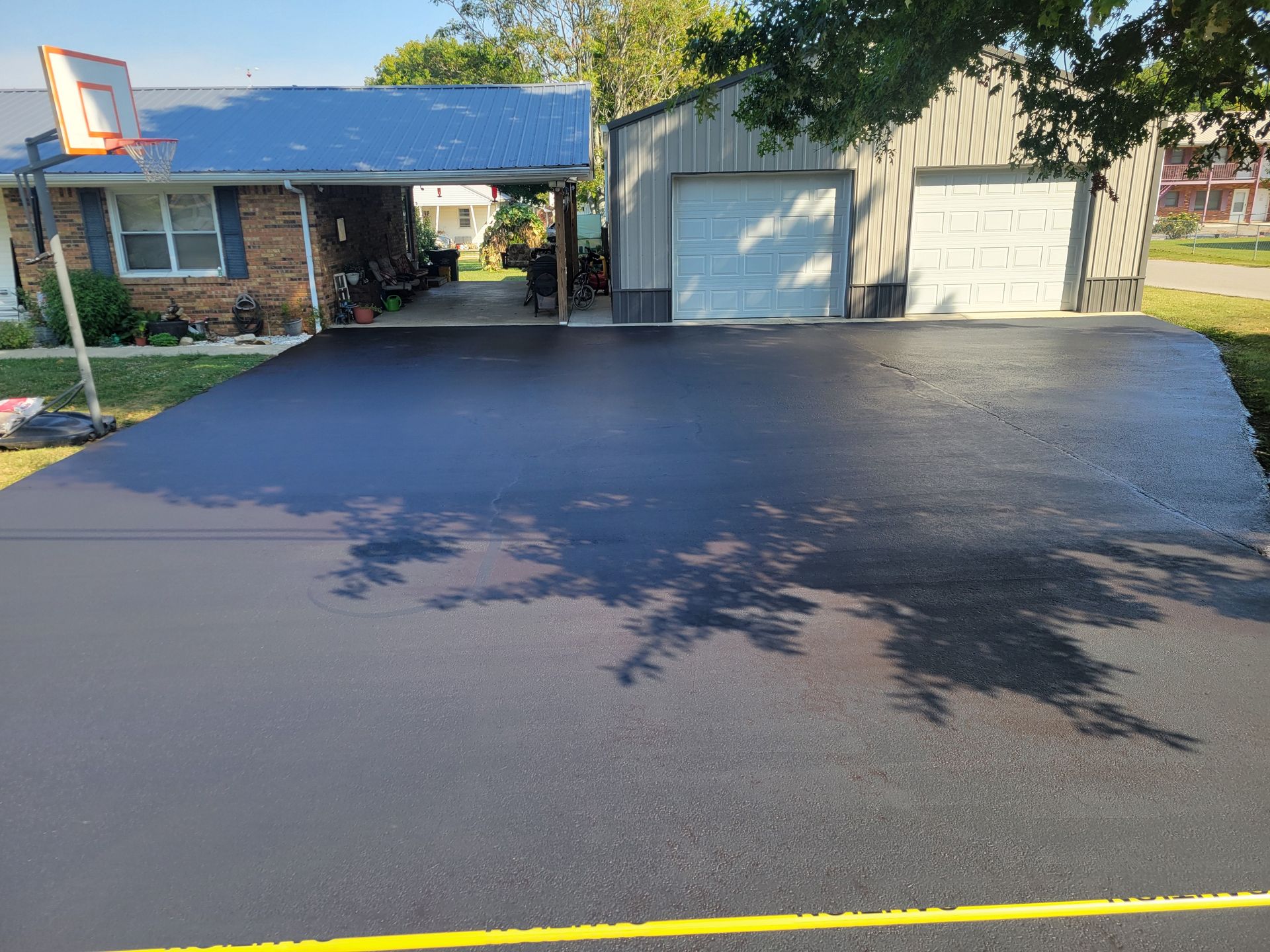 A roller is sitting on top of a pile of asphalt.
