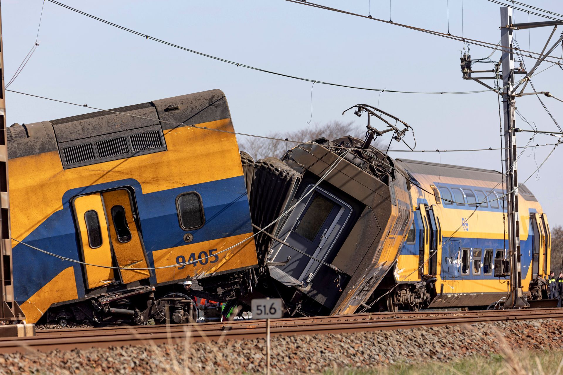 A yellow and blue train with the number 9435 on it