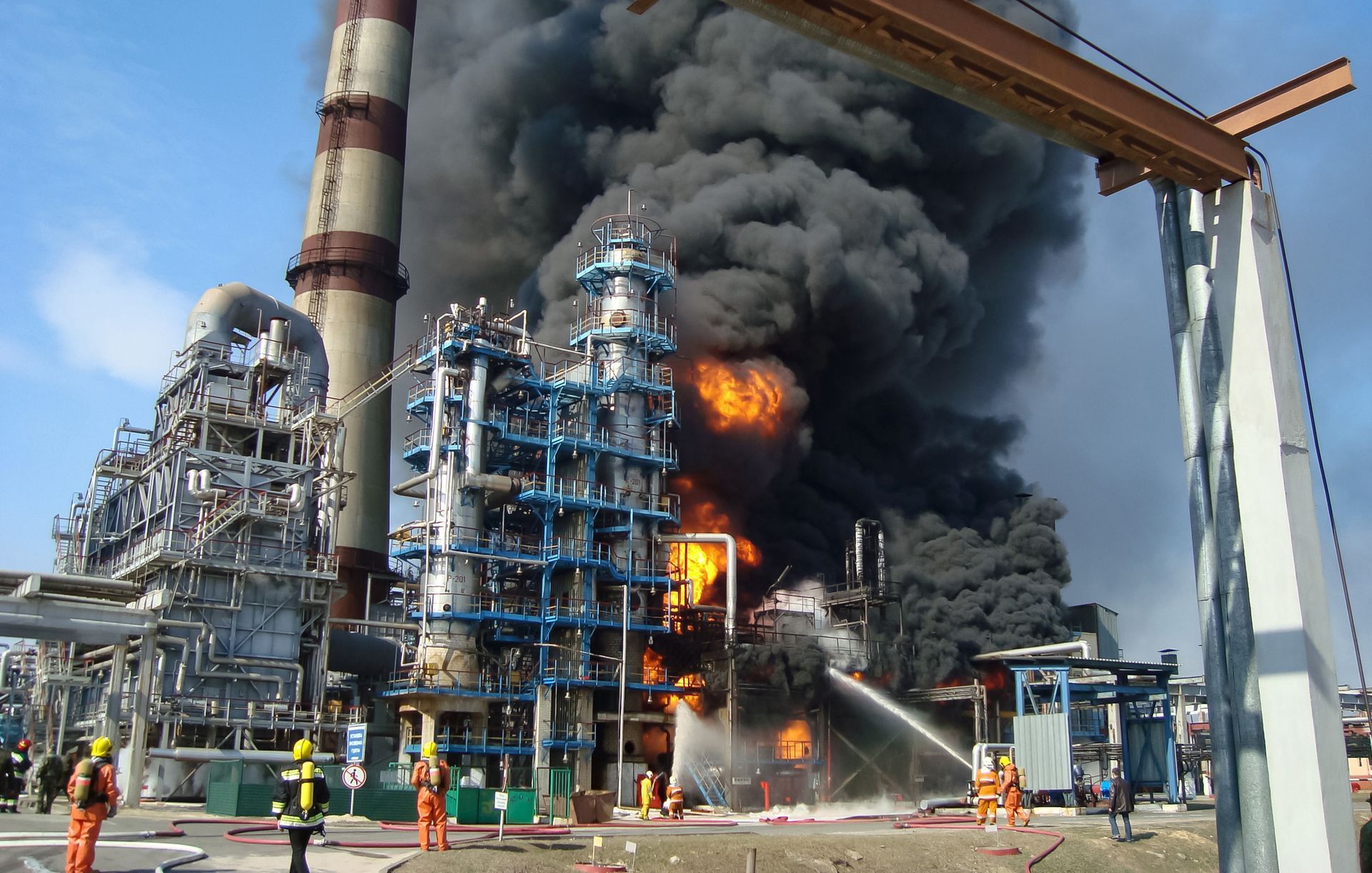 A large factory with smoke coming out of the chimneys