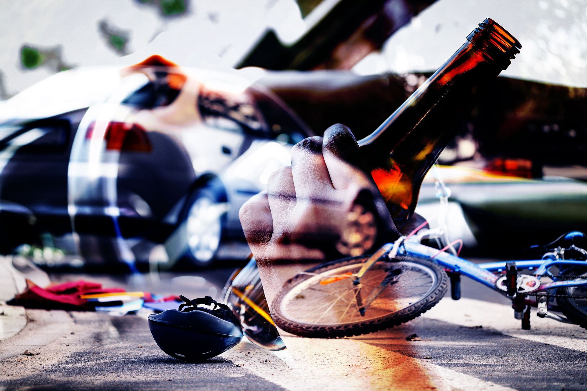 A person is holding a bottle of beer next to a bicycle.