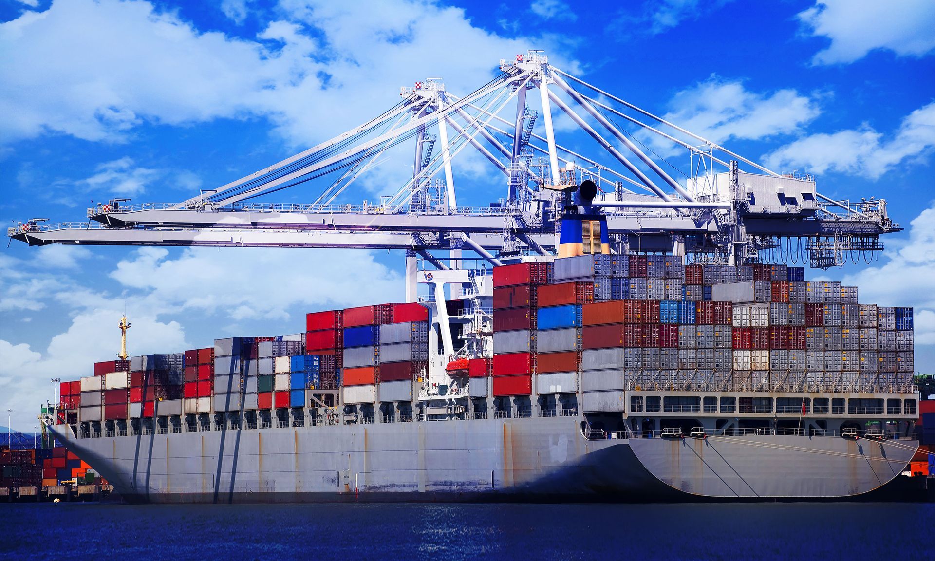 A large container ship is docked at a port.