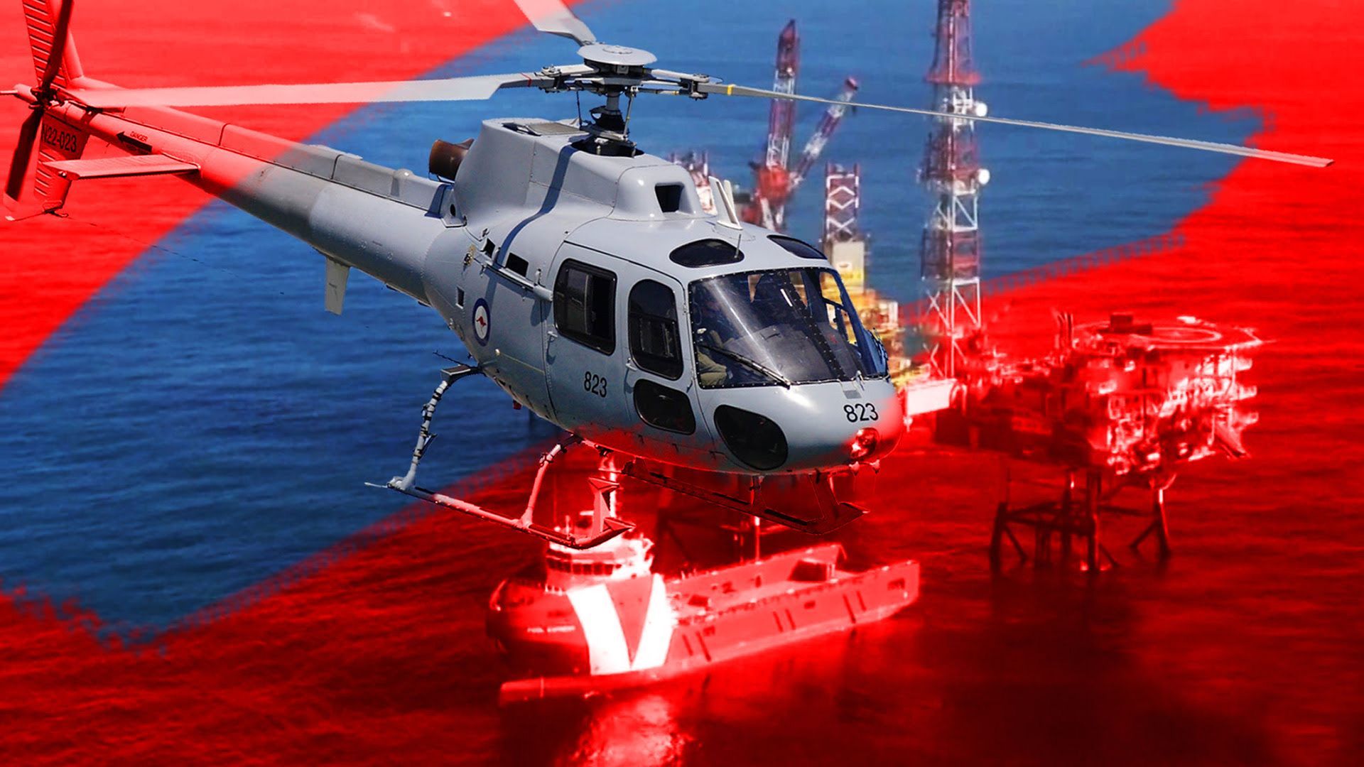 A helicopter is flying over a maritime explosion emergency