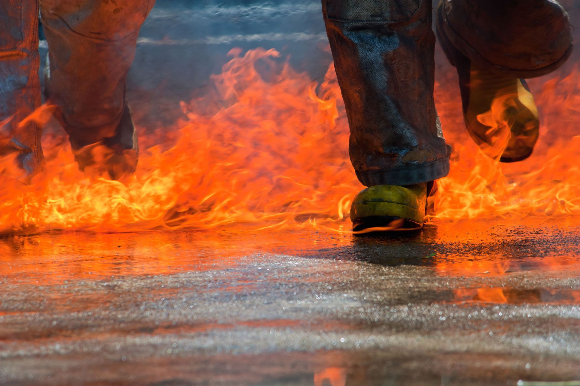 A person is walking through a fire on the ground.