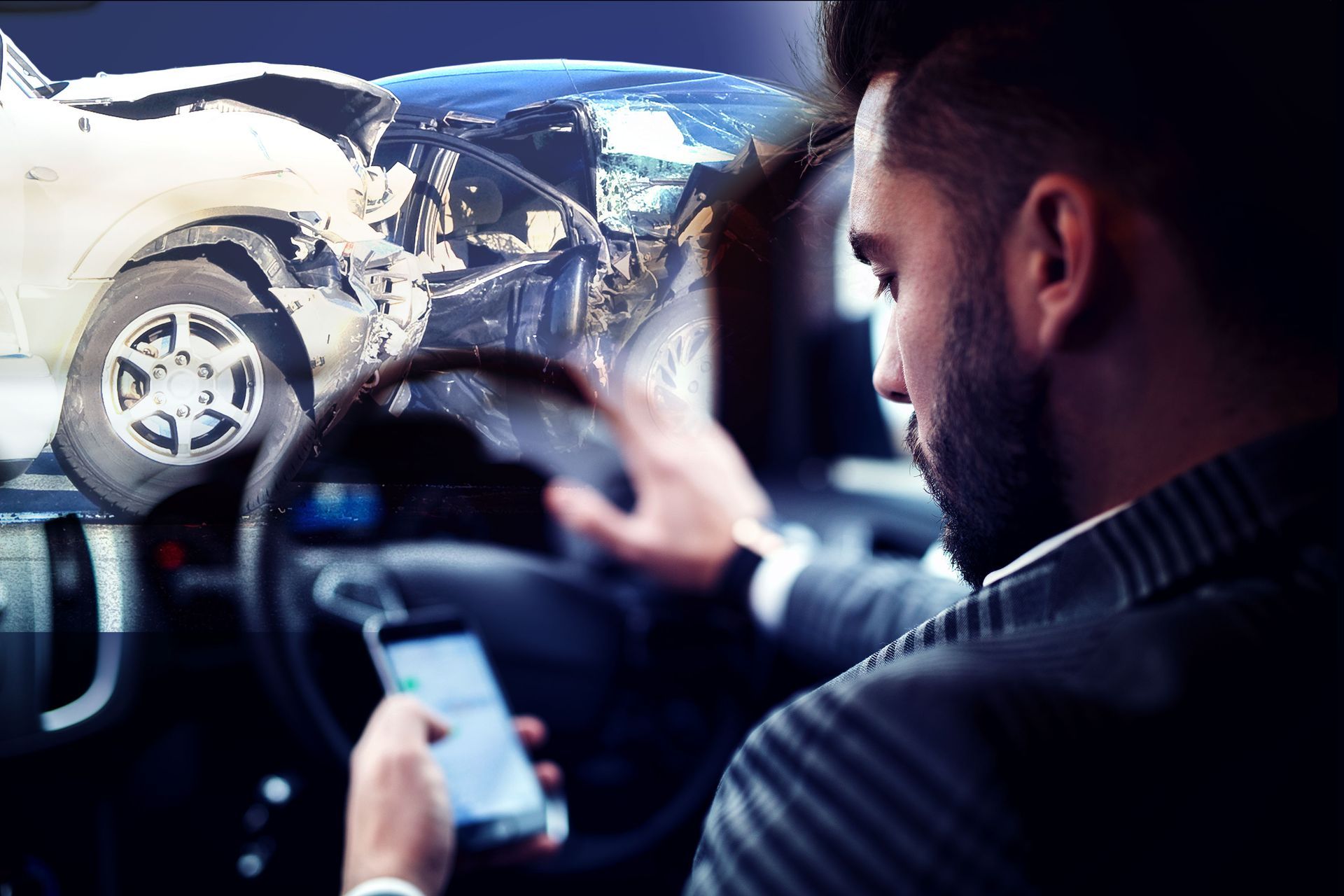 A man is driving a car and looking at his phone.