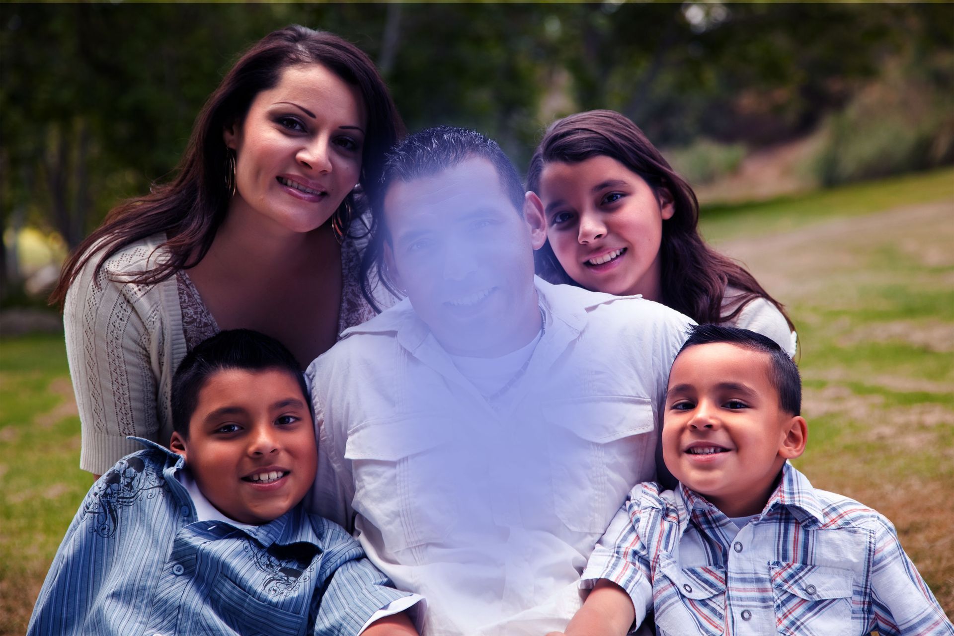 A family is posing for a picture with a ghost in the background.