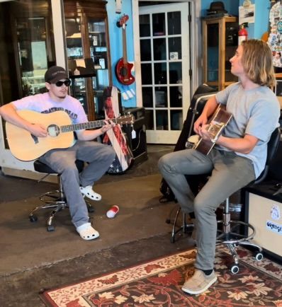 A row of marshall electric guitars hanging from the ceiling