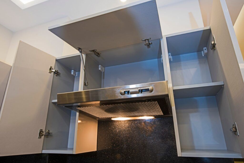Kitchen Cabinets Open Around a Stainless Steel Range Hood — SPW Engineering & Powdercoating In Ballarat, VIC