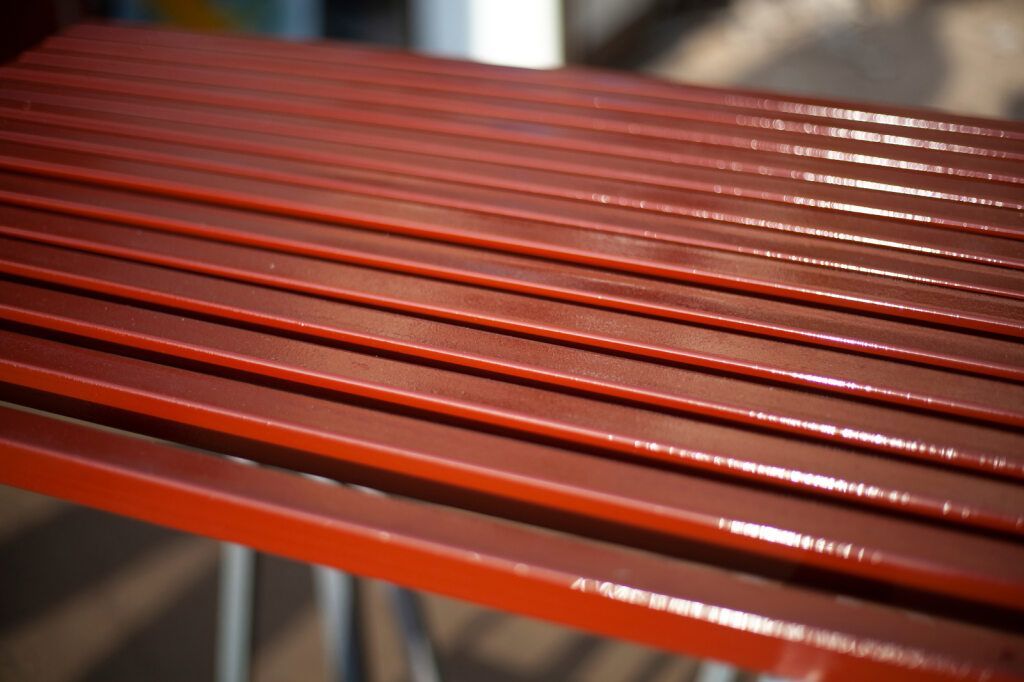 Two Shiny Chrome Wire Wheels Hanging on a Rack in a Workshop — SPW Engineering & Powdercoating In Ballarat, VIC