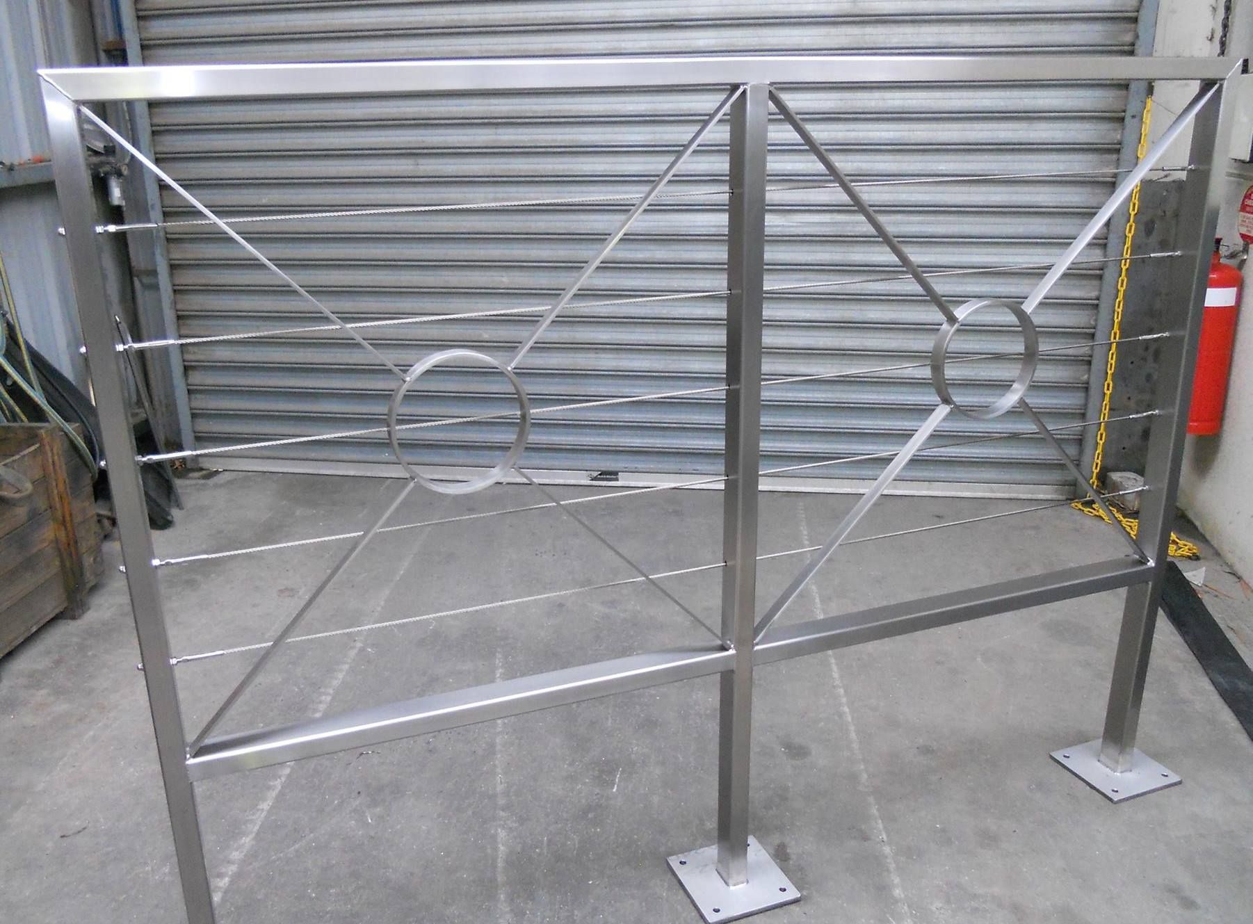 Two Shiny Chrome Wire Wheels Hanging on a Rack in a Workshop — SPW Engineering & Powdercoating In Ballarat, VIC