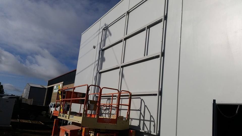 White Building Exterior Under Construction With a Lift in Front — SPW Engineering & Powdercoating In Ballarat, VIC