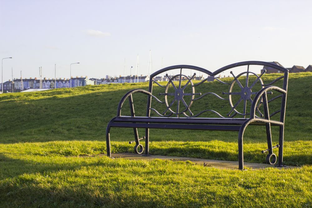 Black Metal Bench on a Grassy Hill — SPW Engineering & Powdercoating In Ballarat, VIC