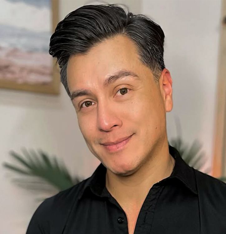 A close up of Heriberto Romo with a smile on his face.