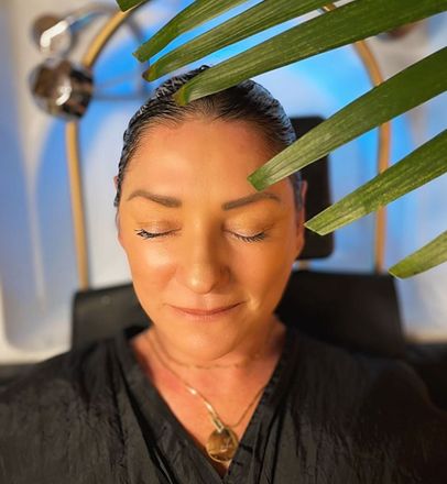 A woman with her eyes closed is getting a massage