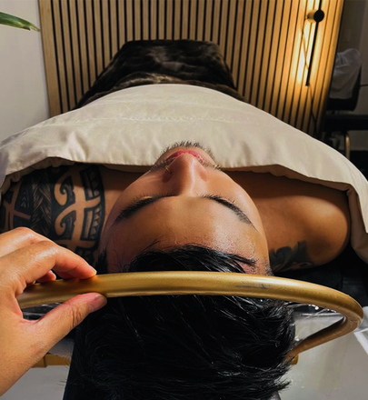 A man with a tattoo on his arm is getting a massage