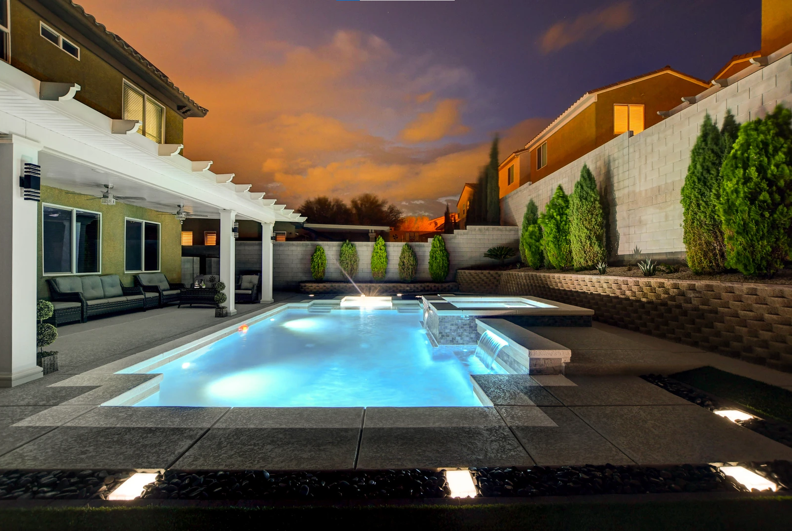 A large swimming pool in the backyard of a house
