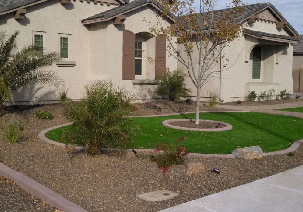 A house with a lush green lawn in front of it